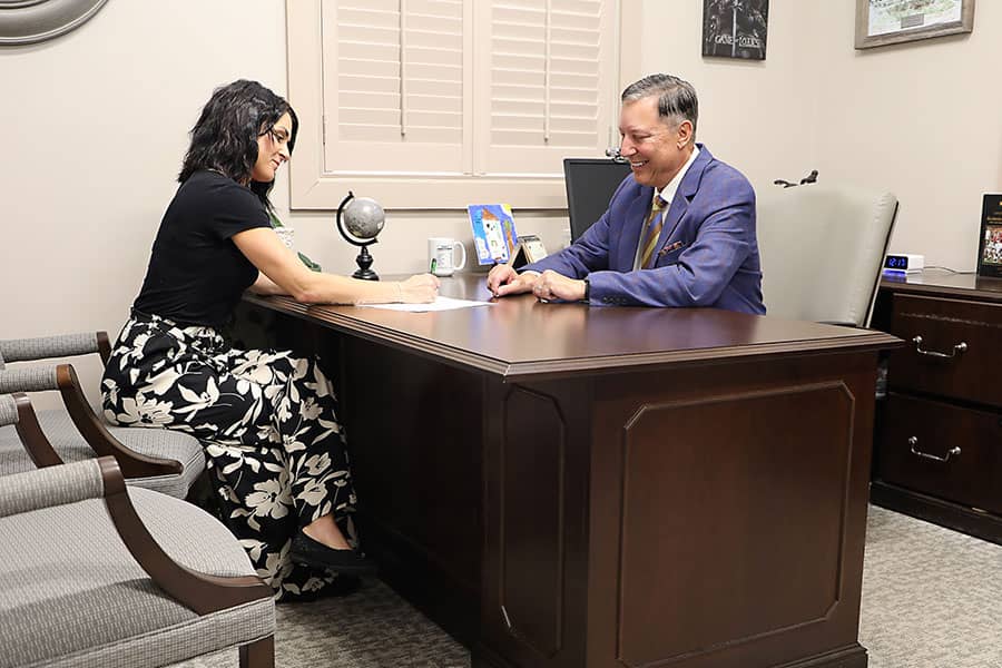 A banker at a desk working with a female customer